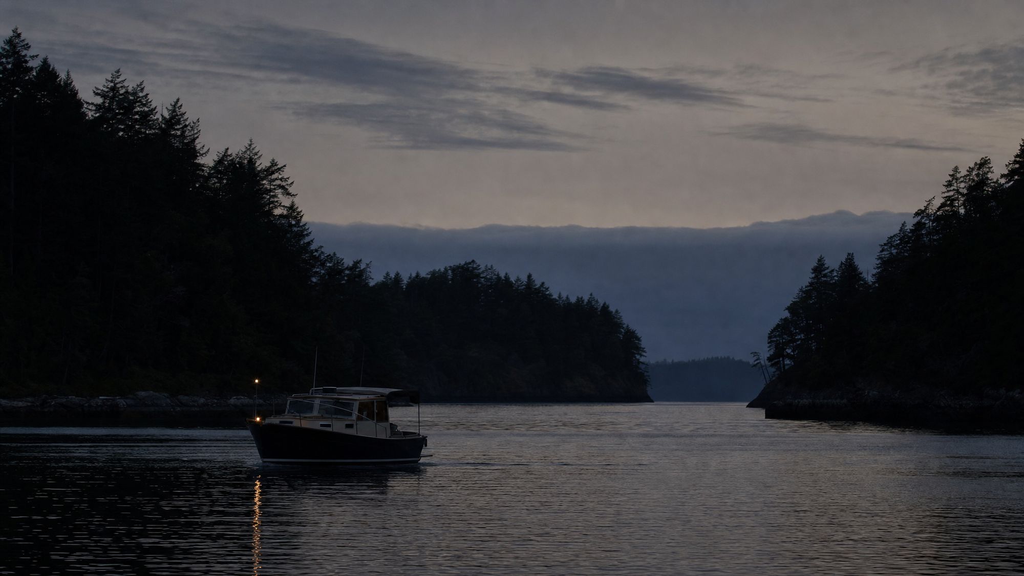 Afterglow returning toward harbor under cool evening light.